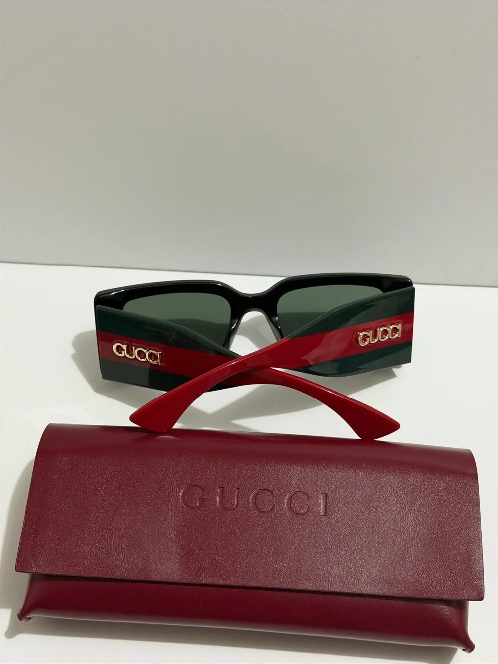 Gucci Black Frame Sunglasses with Red Temples and Gold Logo